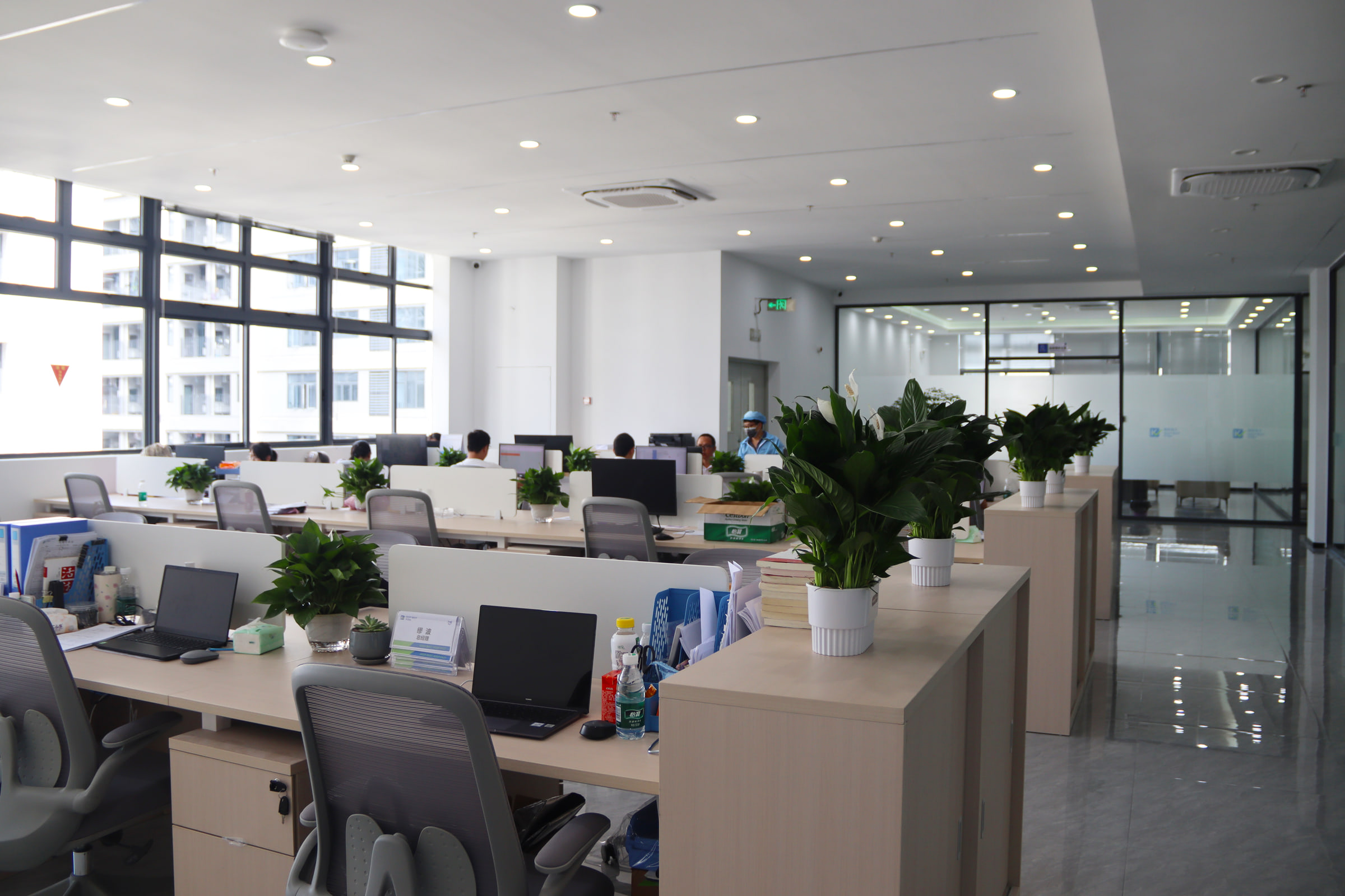 KeepBest office workspace with team members working at their desks