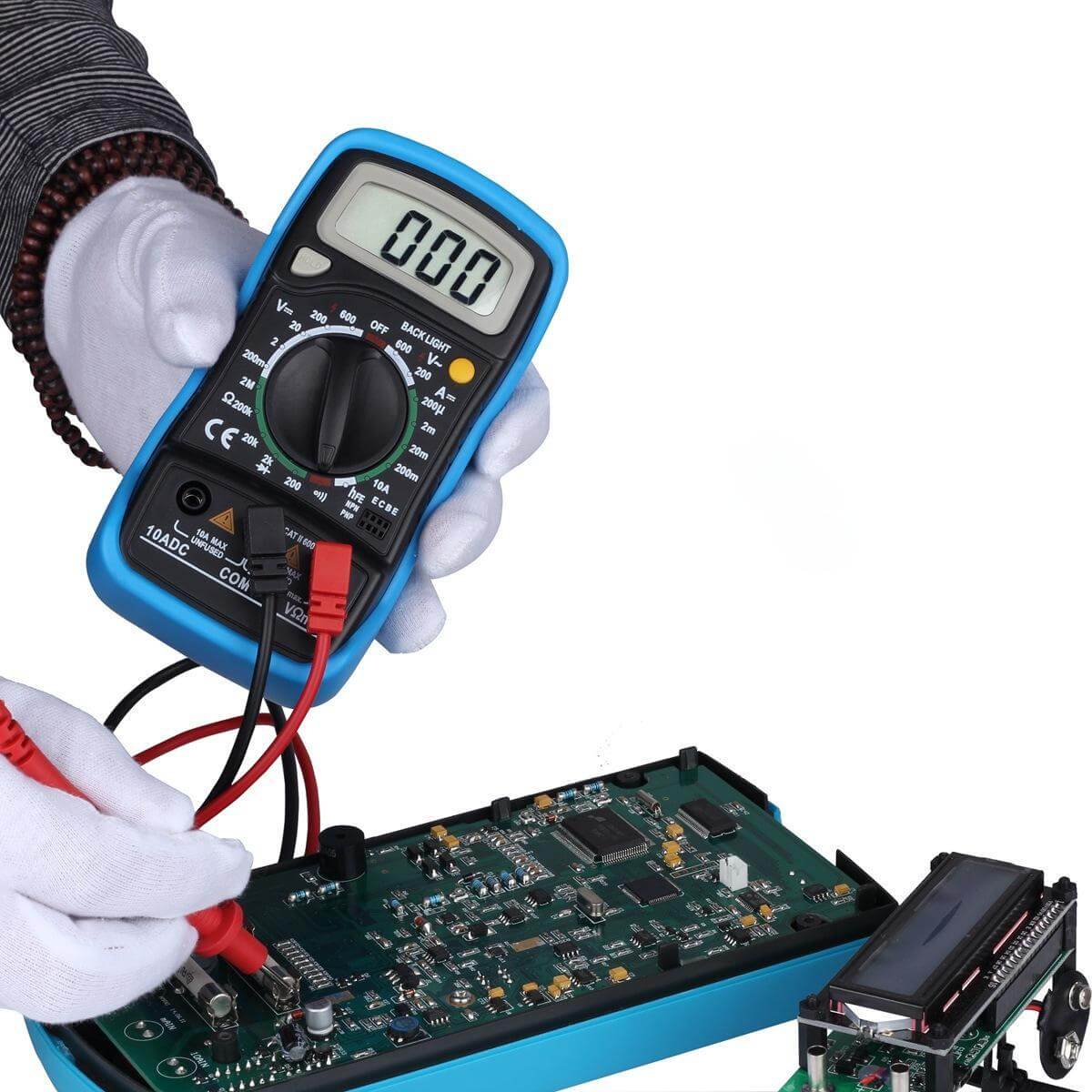 A multimeter testing a PCB